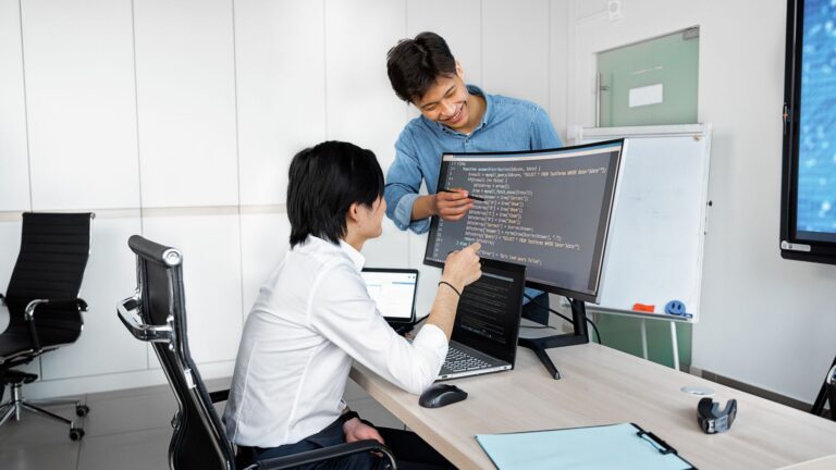 Procurement Checks for Product Teams Before Buying Into a Public-Record API Engineers reviewing code on a monitor: Procurement Checks for Product Teams Before Buying Into a Public-Record API