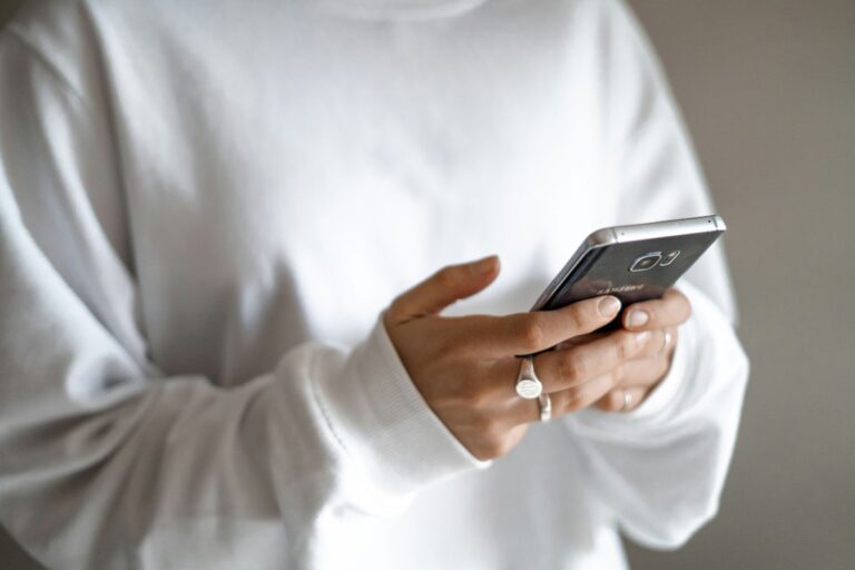 Regaining control of spending means planning purchases and prioritising debt repayments Regaining control of spending means planning purchases and prioritising debt repayments: a person in a white jumper checking their household budget on a mobile phone